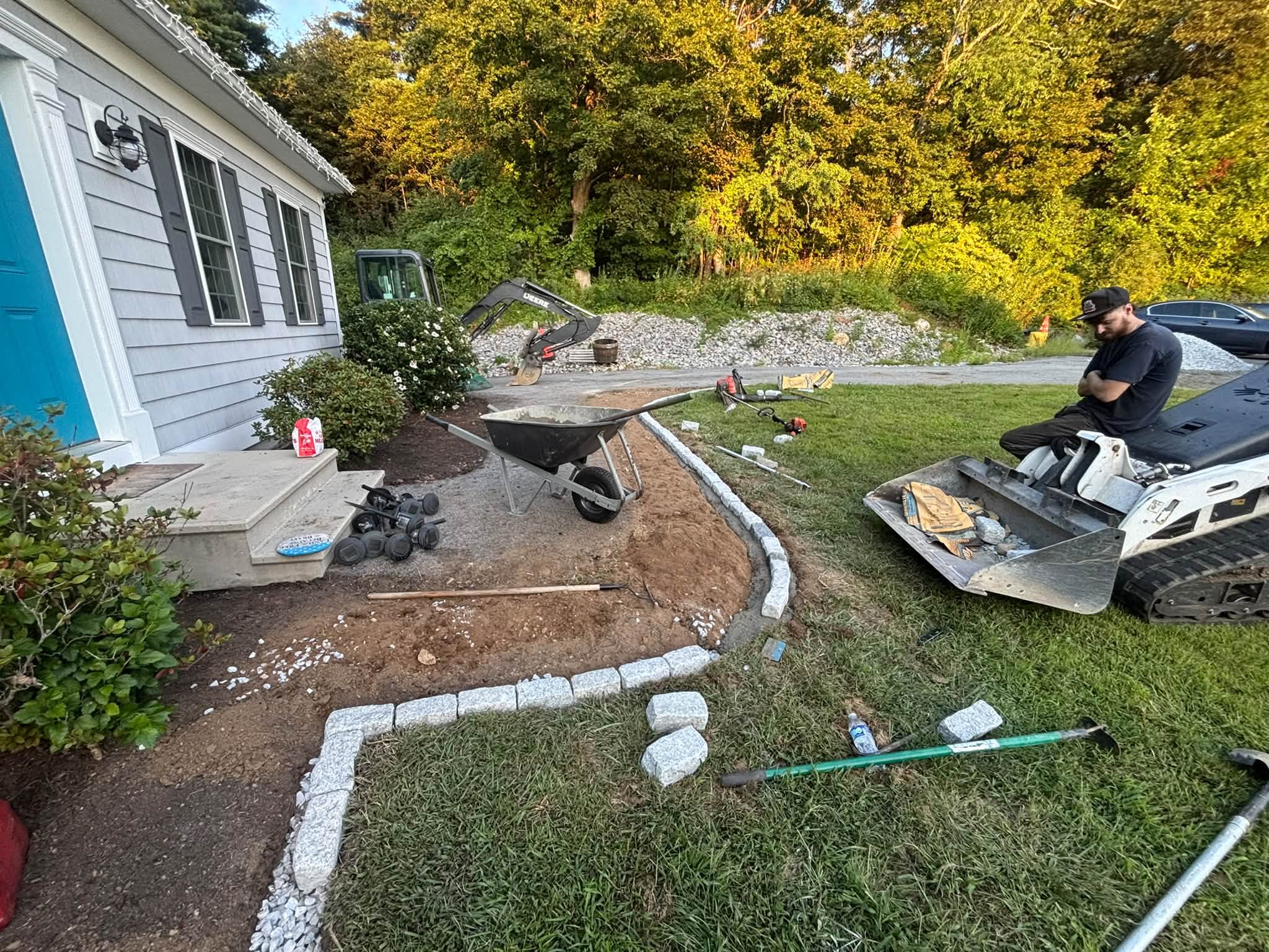 Setting cobblestones — Spencer, MA border project